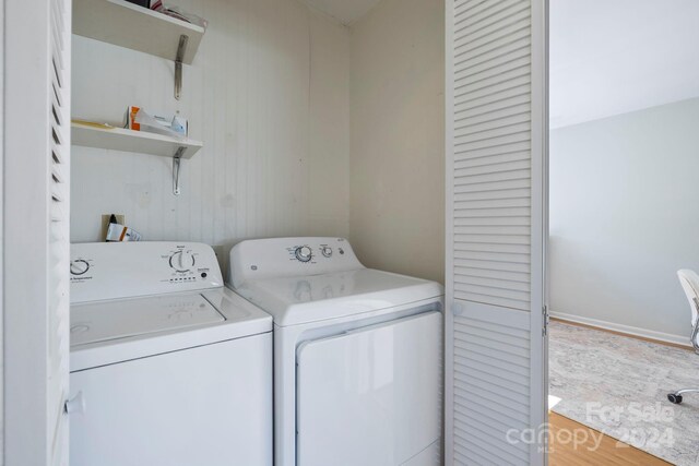 washroom featuring separate washer and dryer and wood-type flooring