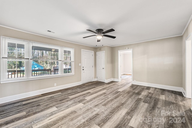 empty room featuring hardwood / wood-style flooring, ceiling fan, and crown molding