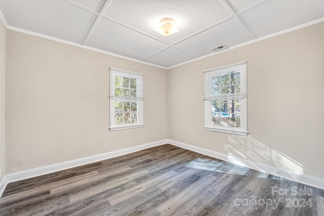 empty room with coffered ceiling, plenty of natural light, and dark hardwood / wood-style floors