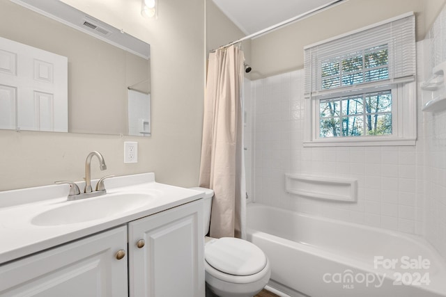 full bathroom featuring vanity, toilet, and shower / bath combo with shower curtain