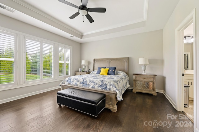 bedroom with ceiling fan, dark hardwood / wood-style flooring, connected bathroom, and multiple windows