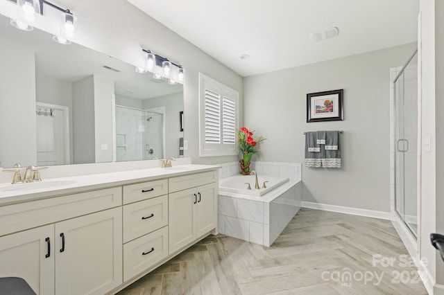 bathroom with vanity and separate shower and tub