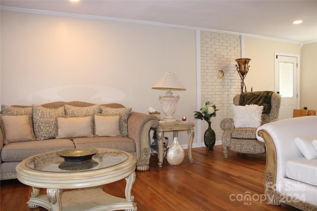 living room featuring dark hardwood / wood-style flooring and ornamental molding