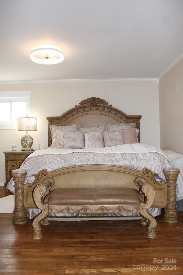 bedroom featuring wood-type flooring and ornamental molding