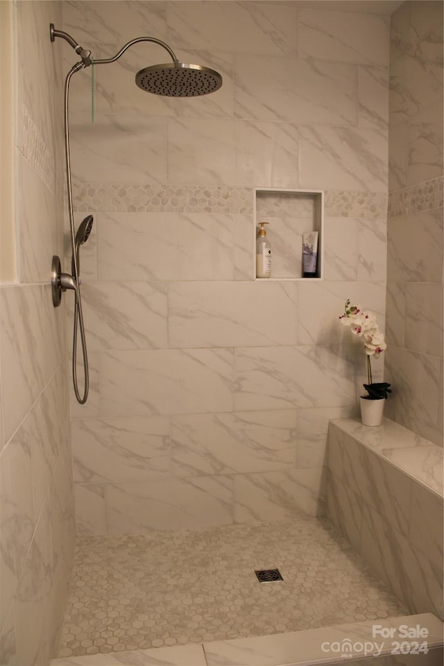 bathroom with a tile shower