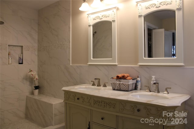 bathroom featuring vanity, tasteful backsplash, and tile walls