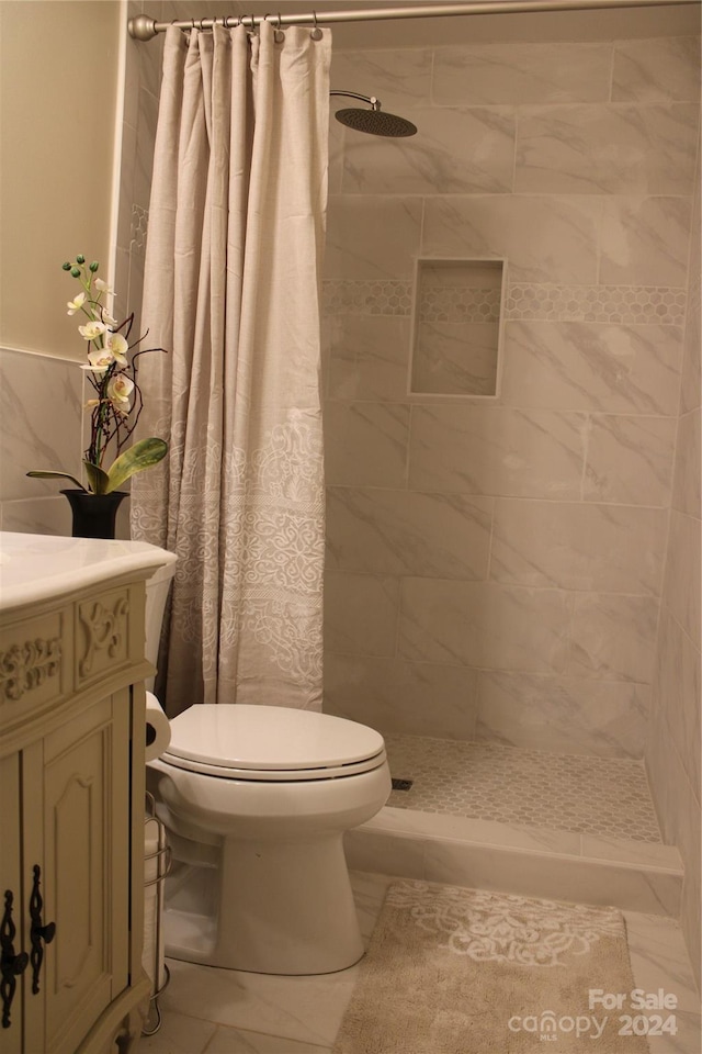 bathroom featuring tile patterned floors, curtained shower, and toilet