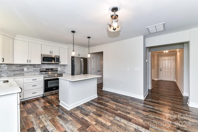 kitchen with dark hardwood / wood-style floors, white cabinets, stainless steel appliances, and decorative light fixtures