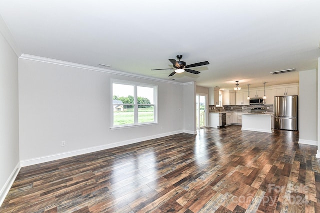 unfurnished living room with crown molding, dark hardwood / wood-style flooring, and ceiling fan