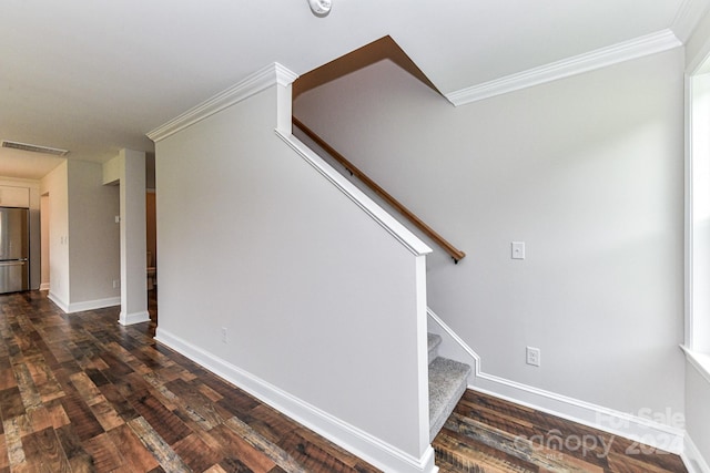 stairs with hardwood / wood-style floors and crown molding