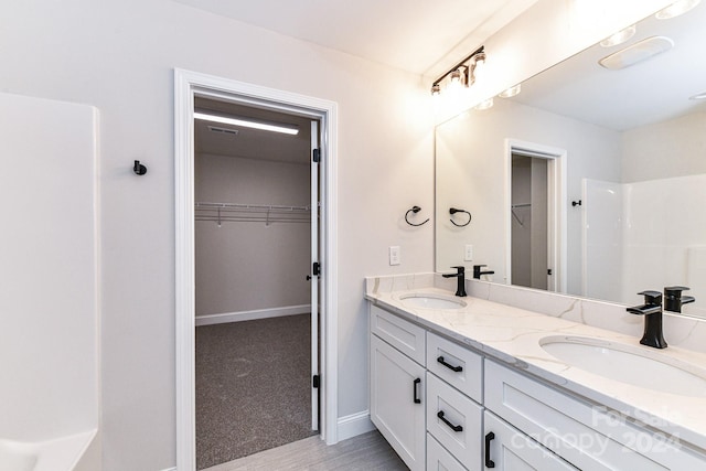 bathroom with vanity and walk in shower