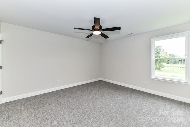 empty room featuring carpet flooring and ceiling fan