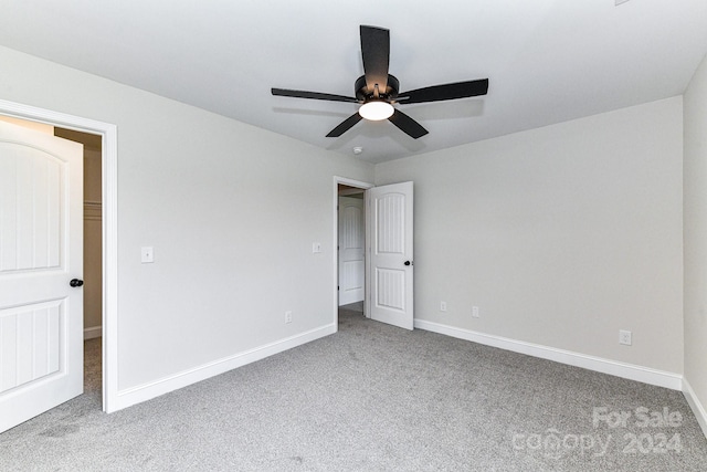 unfurnished bedroom featuring ceiling fan and light carpet