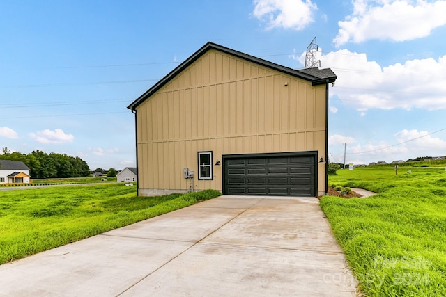 view of side of home with a yard and a garage