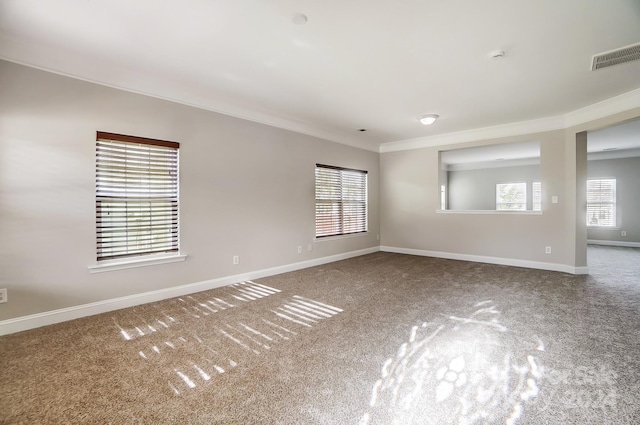 carpeted spare room with crown molding