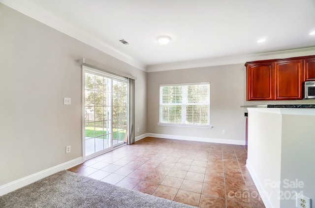 unfurnished dining area with light tile patterned flooring and ornamental molding