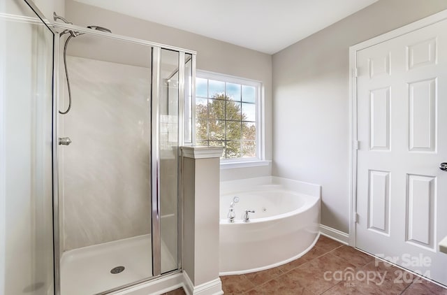 bathroom with tile patterned floors and independent shower and bath