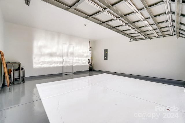 garage featuring electric panel and water heater