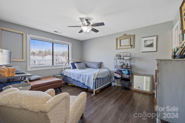 bedroom with ceiling fan and dark hardwood / wood-style flooring