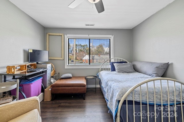 bedroom with dark hardwood / wood-style floors and ceiling fan