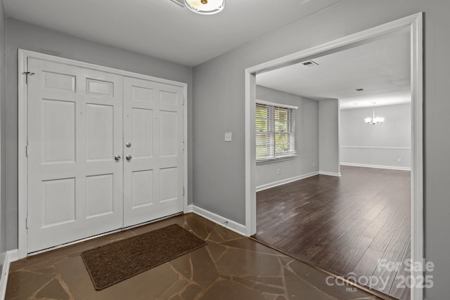 entryway featuring a notable chandelier