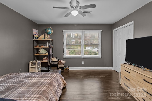 bedroom with ceiling fan, a closet, and dark hardwood / wood-style floors