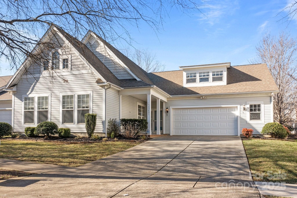 view of front property with a front lawn and a garage