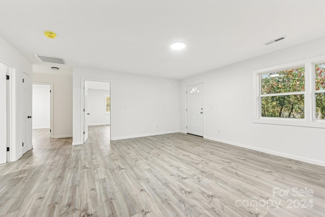 empty room with light hardwood / wood-style flooring