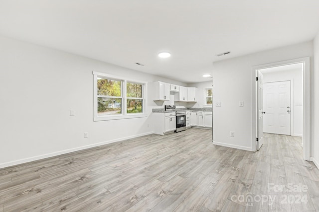 unfurnished living room featuring light wood-type flooring