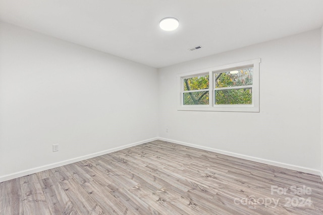 spare room with light wood-type flooring