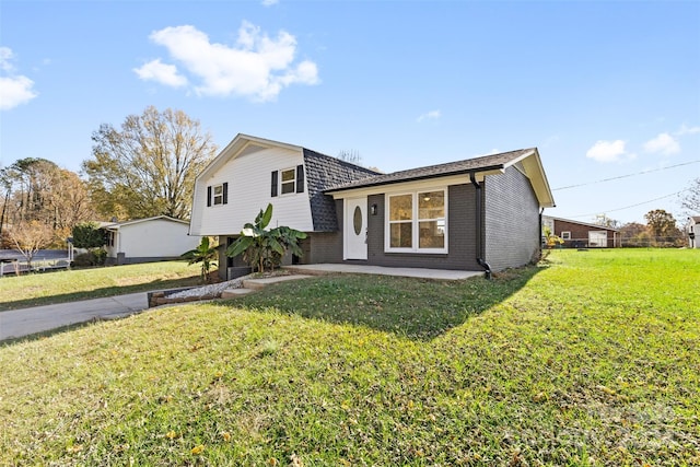 tri-level home featuring a patio and a front yard