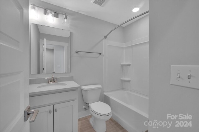 full bathroom featuring hardwood / wood-style floors, vanity, tub / shower combination, and toilet