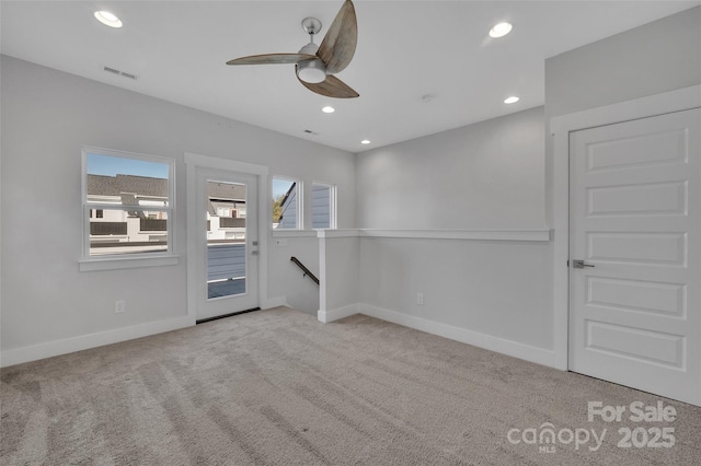 carpeted spare room with visible vents, baseboards, recessed lighting, and a ceiling fan