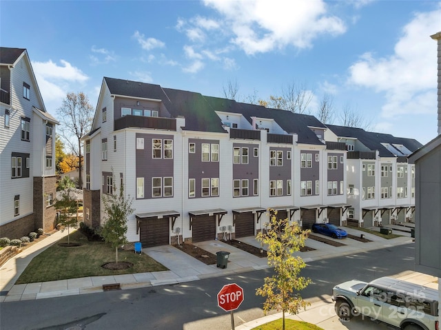 view of building exterior with a residential view and an attached garage
