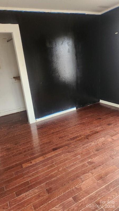 unfurnished room featuring wood-type flooring