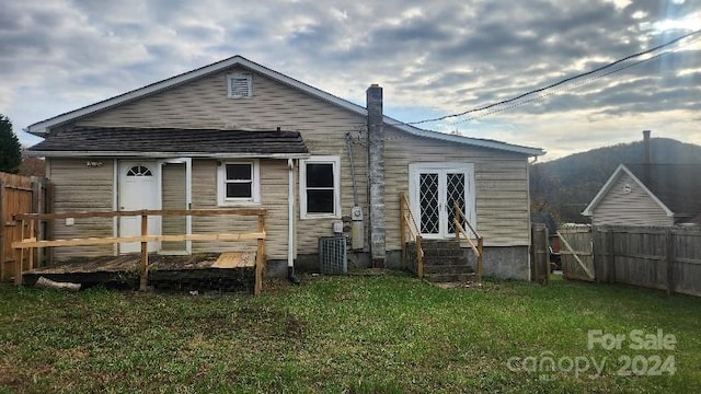 rear view of property with a lawn