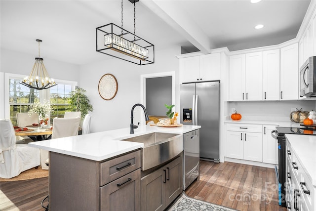 kitchen featuring a chandelier, white cabinets, dark wood-type flooring, and appliances with stainless steel finishes