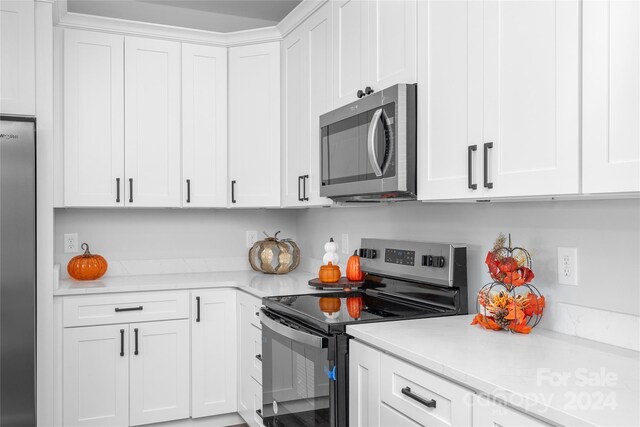 kitchen with white cabinetry and stainless steel appliances