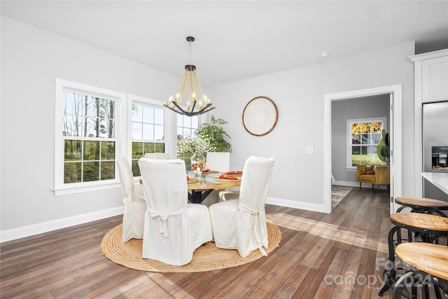 dining area featuring a chandelier, dark hardwood / wood-style floors, and a healthy amount of sunlight