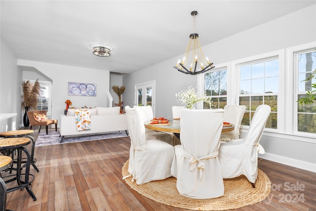 dining area with a chandelier and wood-type flooring