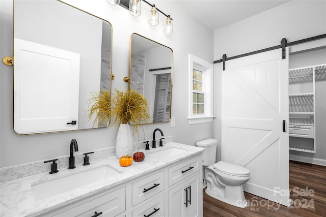 bathroom featuring wood-type flooring, vanity, and toilet