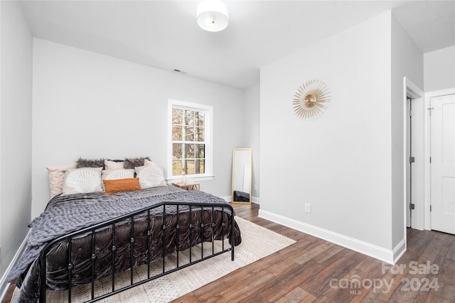 bedroom featuring dark hardwood / wood-style flooring