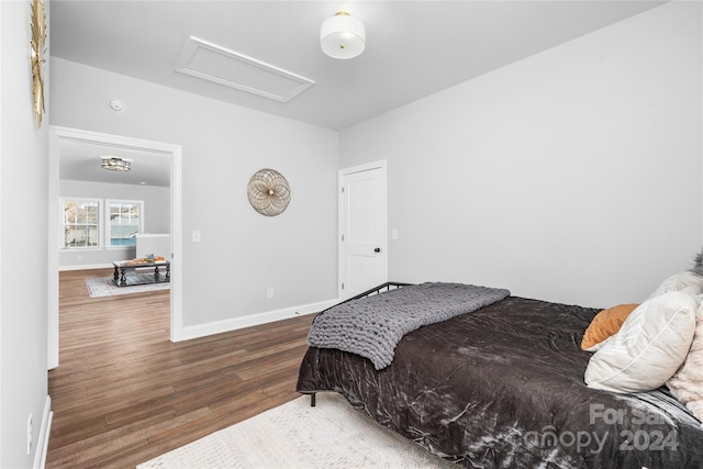 bedroom with dark hardwood / wood-style floors