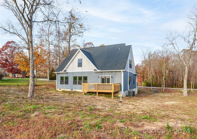 rear view of property featuring central air condition unit and a wooden deck