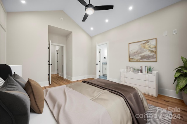 bedroom featuring light wood-type flooring, vaulted ceiling, and ceiling fan