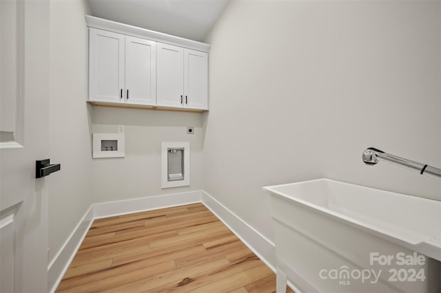 laundry room with hookup for a washing machine, light hardwood / wood-style flooring, cabinets, and hookup for an electric dryer