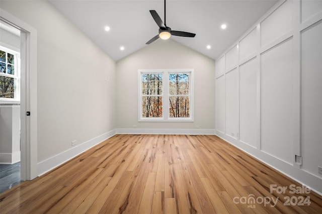 interior space featuring light hardwood / wood-style floors, multiple windows, and lofted ceiling