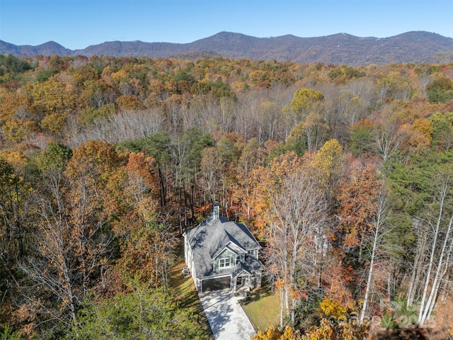 drone / aerial view featuring a mountain view and a view of trees