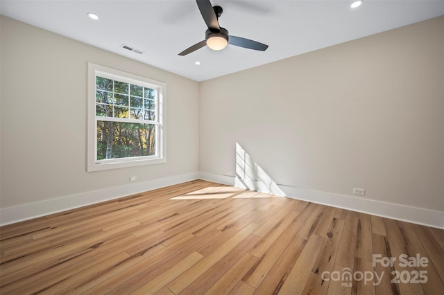 empty room with visible vents, a ceiling fan, wood finished floors, recessed lighting, and baseboards