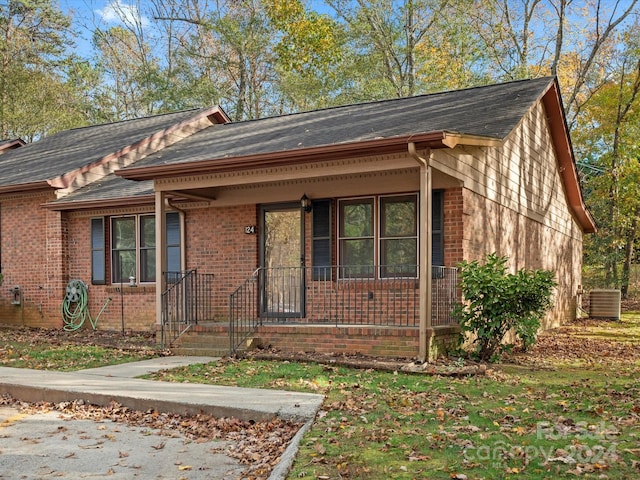 view of front of house featuring a porch and central AC